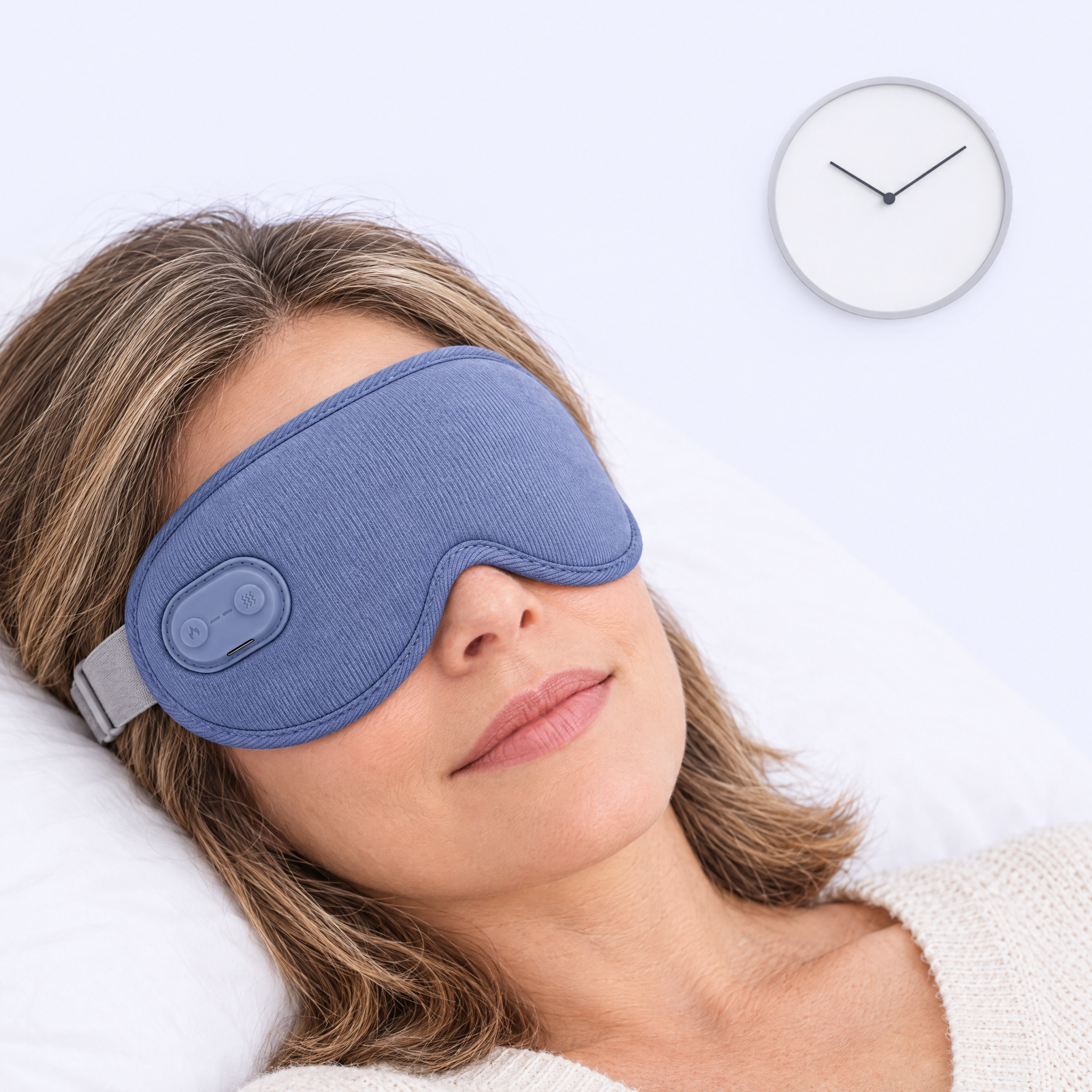Woman relaxing in bed wearing the Ocuelle warm compress mask